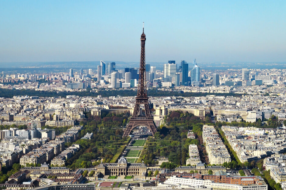 Image of the Paris cityscape on a sunny day, including the Eiffel Tower.